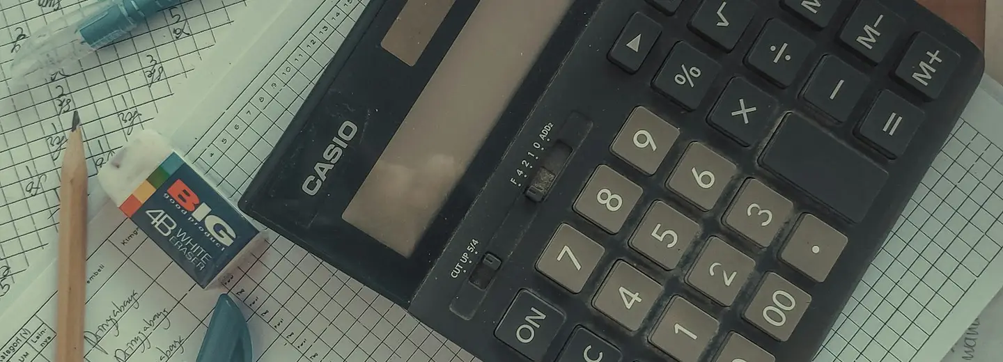 Desk calculator on squared paper with a pencil