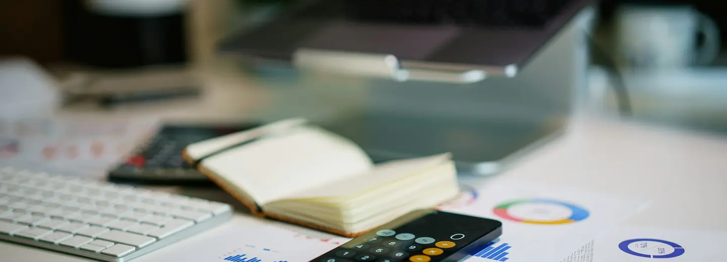 Phone showing financial charts on an office desk